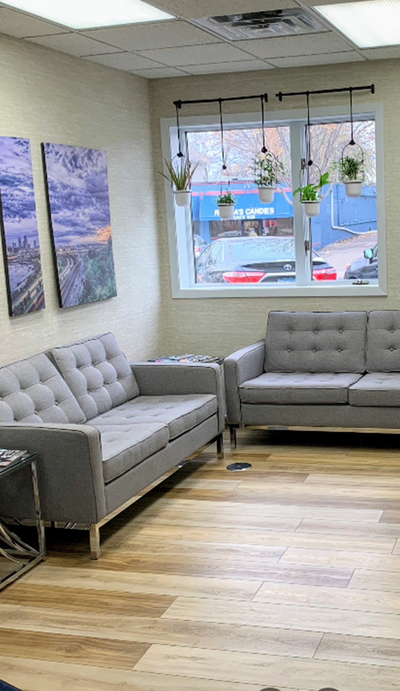The image shows a modern dental or medical office interior with a dental chair, equipment, and a clean, professional environment.